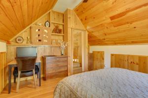 a bedroom with a bed and a desk with a computer at Private Cabin Rental in the Catskill Mountains! in Hamden