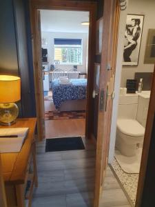 a bathroom with a door leading to a bedroom at Exclusive use of Garden Room!! in Bristol