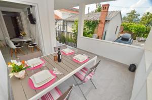 a patio with a table and chairs on a balcony at Sun Ray Apartments in Tivat