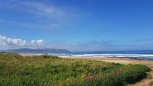 a beach with a bunch of people on the sand at Self-Catering Suite in rural guest house 10 min to Islay Ferry Terminal in Ronachan