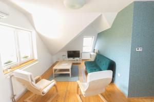 a living room with a green couch and chairs at Hi-Bp Garden city Batsanyi Apartment 3 Rooms, Apartment upstairs near the city train with FREE PARKING in Budapest