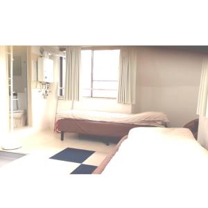 1 dormitorio con 2 camas y ventana en Guest house Shijo K12 D401 en Kyoto