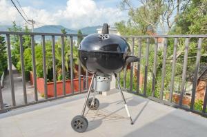 a grill on a stand on a balcony at Sun Ray Apartments in Tivat