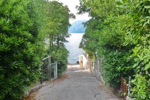 a path with a view of a body of water at Sun Ray Apartments in Tivat