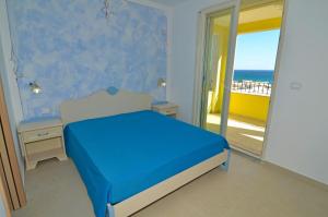 a bedroom with a bed and a view of the ocean at B&B Lu Cantoru in Marina di Pescoluse