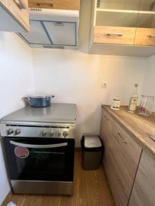 a kitchen with a stove and a trash can at #5 Beach Villa Lipsi Island Getaway in Lipsoi +7 photos