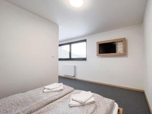 a bedroom with two beds and a tv on the wall at HOTEL DOUBLE RED CARS Museum in Brezno