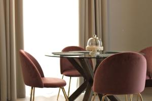 a dining room table with chairs and a glass table with a helmet on it at Palazzo sul Corso-Charming Appartaments in Brindisi +68 photos