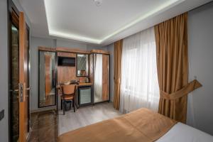 a hotel room with a bed and a desk at Boutique Dedem Hotel Sultanahmet in Istanbul