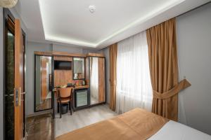 a hotel room with a bed and a desk at Boutique Dedem Hotel Sultanahmet in Istanbul