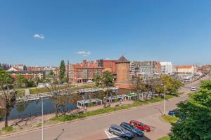 a city street with cars parked in a parking lot at Motława 1 by Grand Apartments in Gdańsk