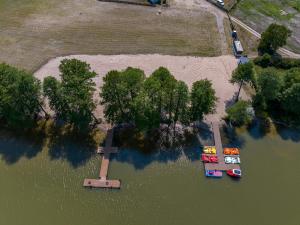 an aerial view of boats in a lake with trees at Palmowe Wzgórze Skoszewo - Domek Dolny in Skoszewo