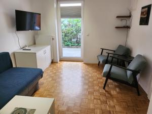 a living room with a couch and a tv at Apartments Old Town in Ljubljana