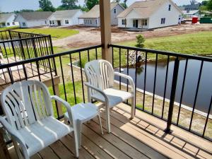 two chairs on a porch with a view of the water at 215 C2 GP-The Treehouse in Coffeyville