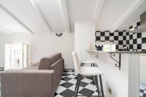 a living room with a couch and a checkered floor at Chess House in Azzano Mella