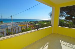 a yellow balcony with a view of the ocean at B&B Lu Cantoru in Marina di Pescoluse