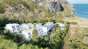 an aerial view of a house on a hill with the ocean at Plakias Bay Hotel in Plakias