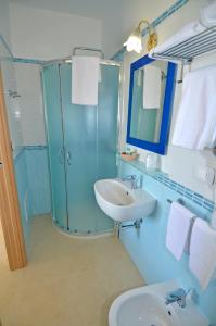 a blue bathroom with a sink and a shower at B&B Lu Cantoru in Marina di Pescoluse