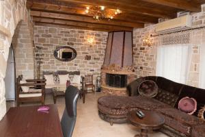 a living room with a couch and a fireplace at Villas Alexandros Petrino in Kalamaki Heraklion