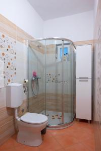 a bathroom with a shower and a toilet at Four Hills Apartment in Žrnovnica