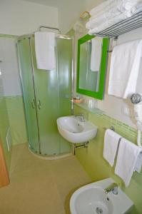 a green bathroom with a sink and a mirror at B&B Lu Cantoru in Marina di Pescoluse +36 photos