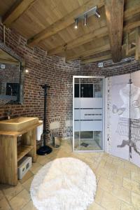 a bathroom with a sink and a glass door at Les Gîtes du Domaine de la Traxène in Coupelle-Vieille