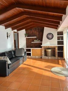 a living room with a couch and a fireplace at Private Apartments Cala Canyelles in Lloret de Mar