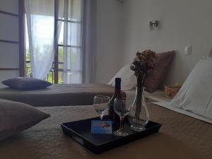 a table with a bottle of wine and two glasses at Marili Apartments in Roda