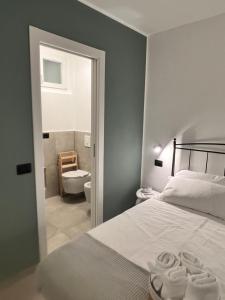 a bedroom with a bed and a bathroom with a toilet at Ca Rota house free parking in Lipomo