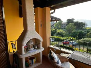 un horno al aire libre en un balcón con vistas en Casa Giulia: un'oasi di pace, en Toscolano Maderno