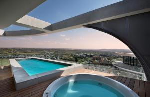 a view from a house with a bath tub on a deck at Ellipse Waterfall Executive Apartments in Midrand