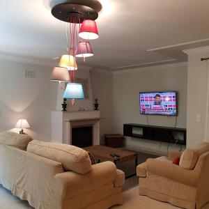 ein Wohnzimmer mit 2 Sofas und einem Flachbild-TV in der Unterkunft Sleep & Surf Ericeira - Portugal in Ericeira