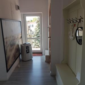 a room with a hallway with a door and a window at Apartament 3 pokoje z balkonem Asklepios in Świnoujście