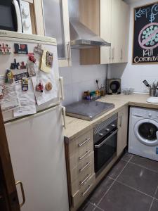 a kitchen with a white refrigerator and a sink at Bedroom to rent in the beach in Valencia