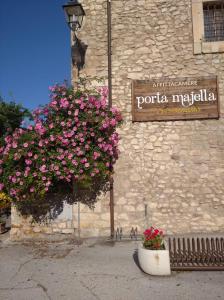 a sign on the side of a building with flowers at Affittacamere Porta Majella in San Valentino in Abruzzo Citeriore