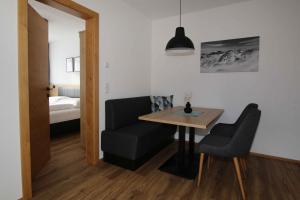 a room with a table and a chair and a bedroom at Apart Christoph in Oetz