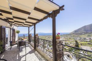 a balcony of a house with a table and chairs at Morning Star Traditional Houses in Pirgos