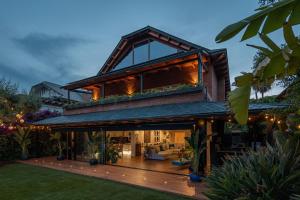 ein Haus mit einem Dach, das nachts beleuchtet wird in der Unterkunft BARCELONA´S TROPICAL OASIS in Sant Just Desvern