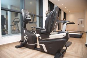 a gym with a cardio machine in a room at Capitole Hotel in Abidjan