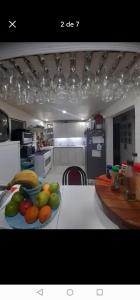 a kitchen with a plate of fruit on a table at Hostal Pura Vida in Santiago