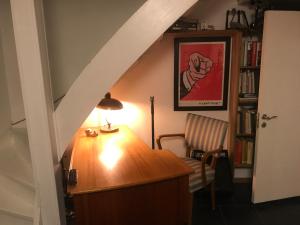 a staircase with a desk and a chair in a room at Bolinderbyn in Järfälla