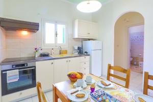 a kitchen with a table and a kitchen with a dining room at Fran Apartments in St. Spyridon Corfu