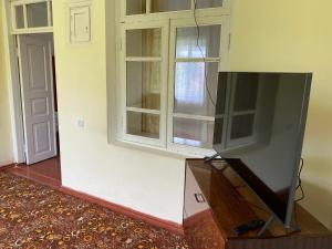 a flat screen tv in a room with a window at Tamara B&B in Dsegh