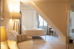 un salon avec un canapé et un lit dans l'établissement Dimore Storiche Casalnuovo, à Conversano