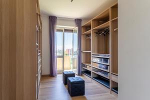 a living room with wooden cabinets and a large window at Livorno - Sea View Apartment! in Livorno
