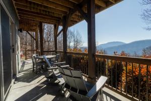 a porch with chairs and tables and a view of the mountains at Time in a Bottle in Black Mountain in Black Mountain