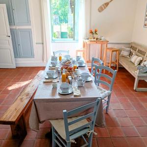 a dining room with a wooden table and chairs at Baladous in Montgaillard-de-Salies