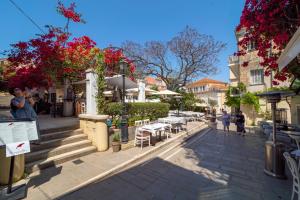 a city street with tables and chairs and buildings at Nymfes Corfu Apartments in Corfu Town