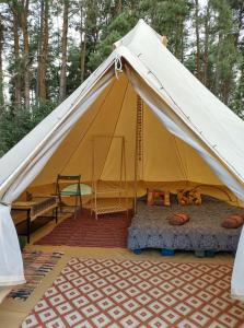 a large tent with a bed and a table at Magic forest 