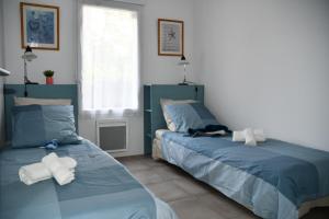 Postel nebo postele na pokoji v ubytování Appartement T3 (plain-pied) et son jardin privatif clos à Vieux Boucau + 16 fotografií